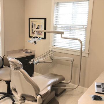 Edgartown Dental group's treatment room with dental chair and equipment.